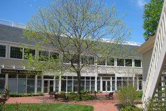 Welcoming brick courtyard and ample parking